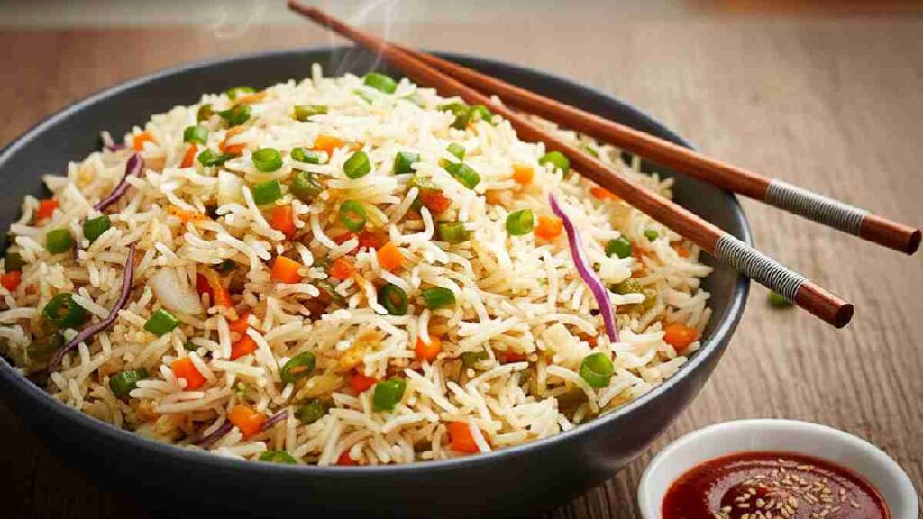 A beautiful bowl of veg fried rice garnished with spring onions.